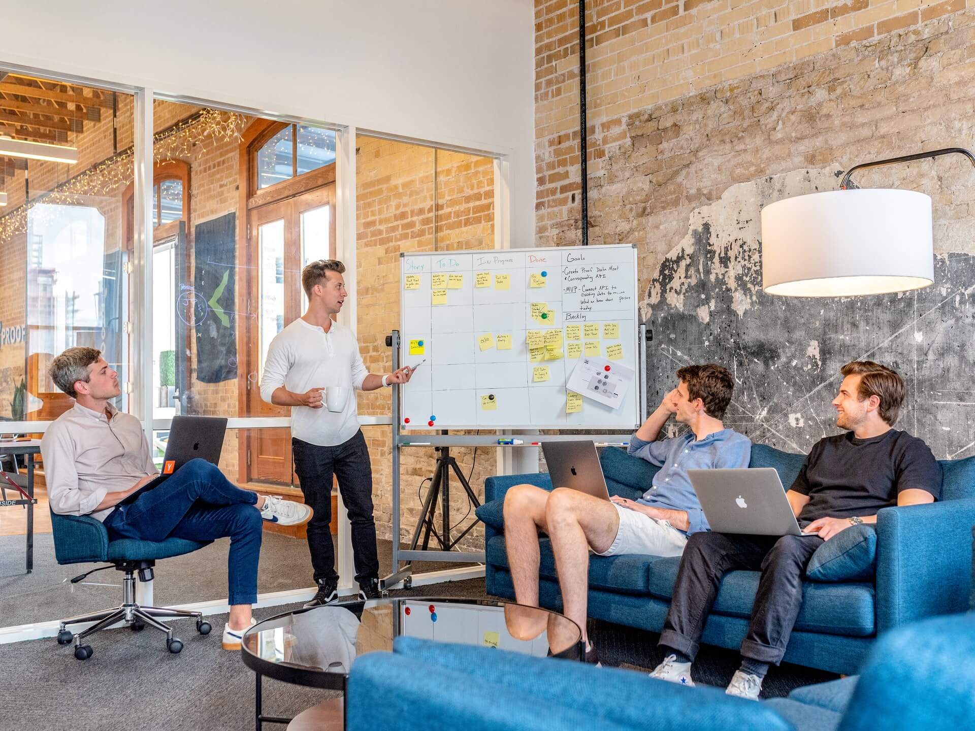 A group of people discussing blog post length at a table in an office.