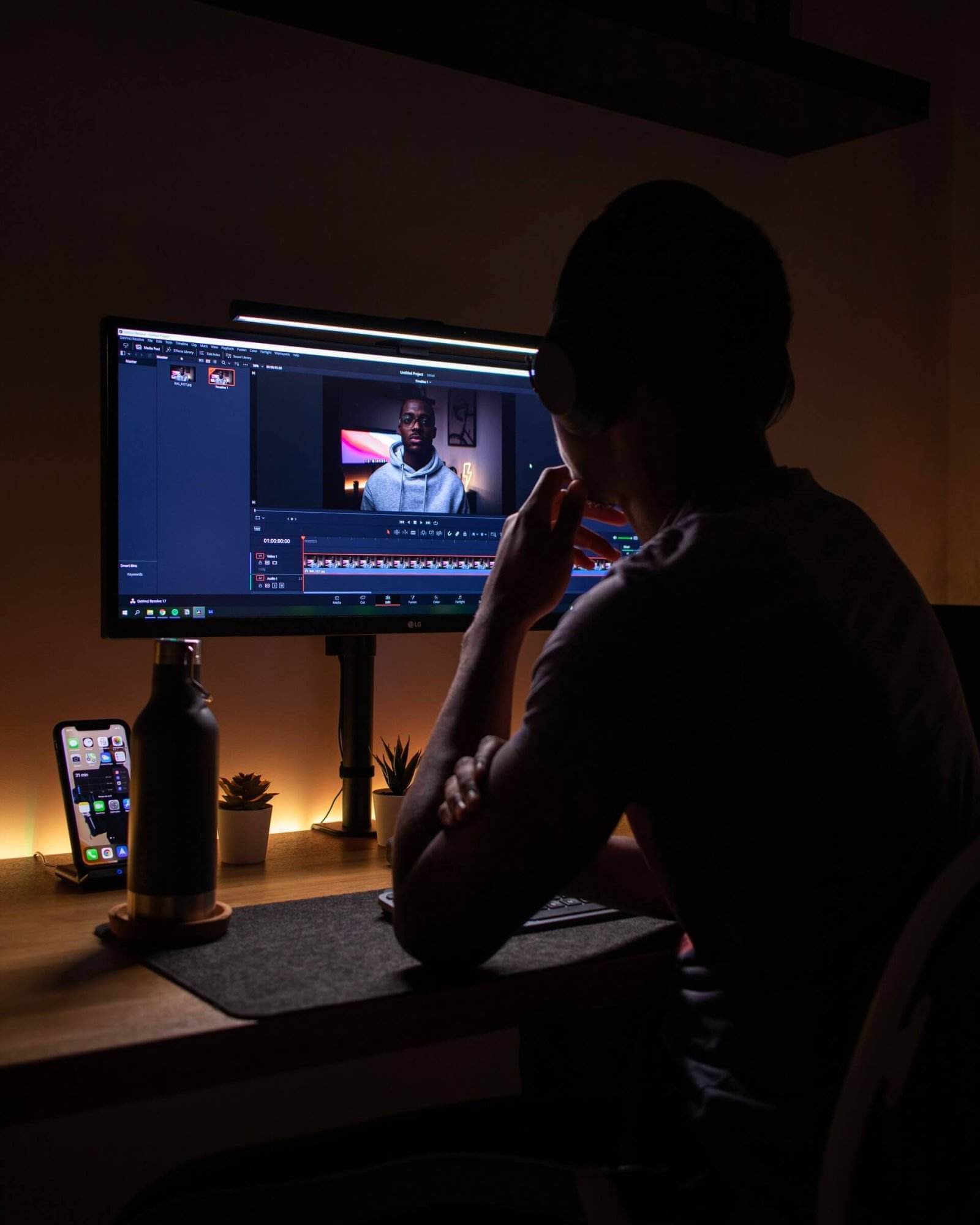 A man earning money as a YouTube blogger at his desk with two monitors.