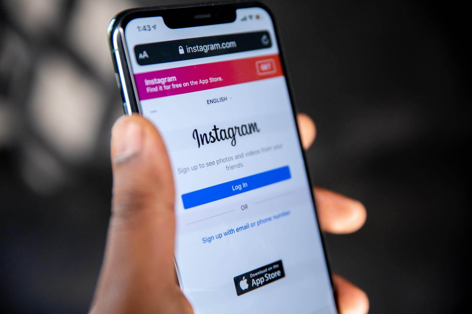 A person holding an iPhone with the Instagram app demonstrating 3 simple steps to remove a personal blog.