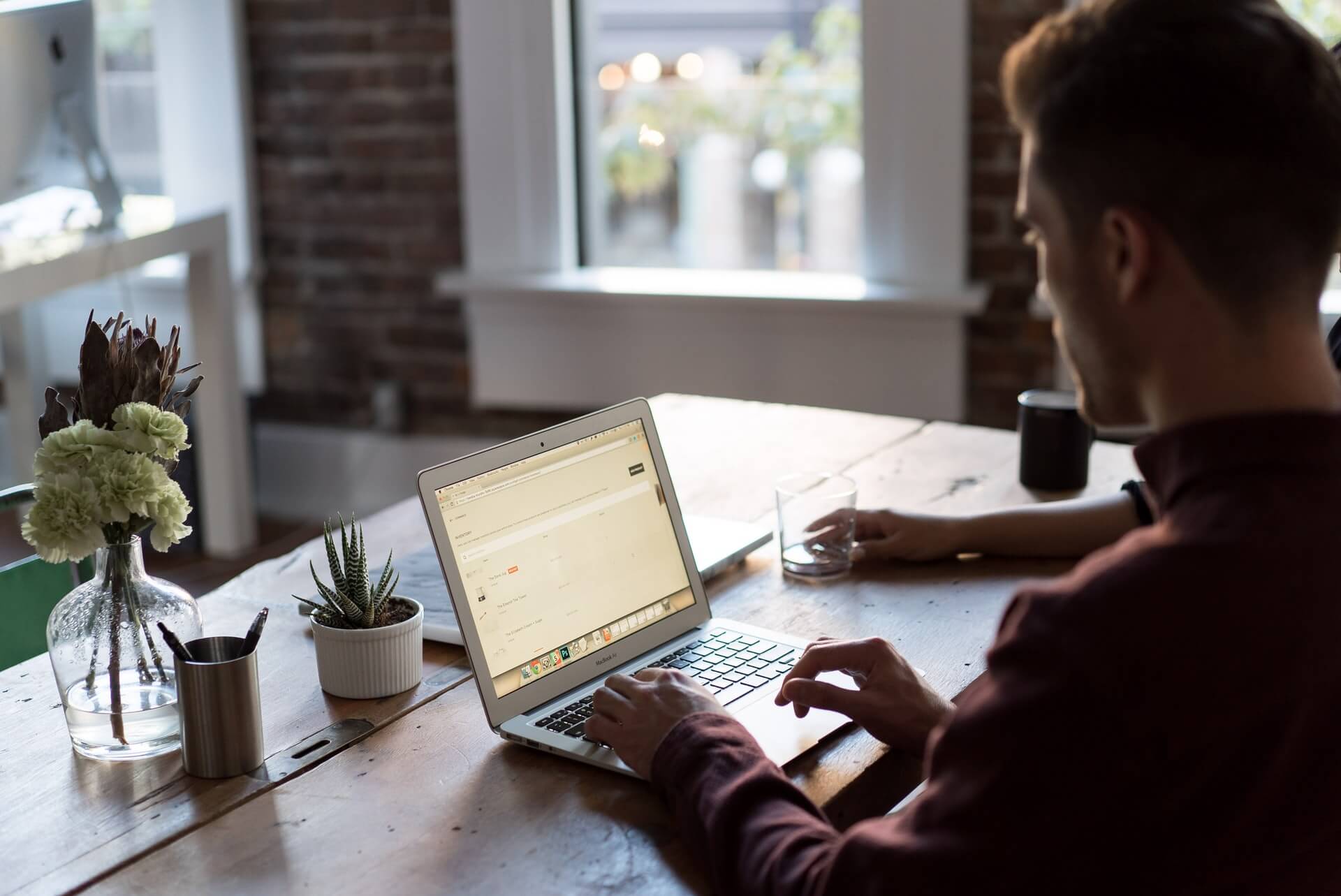 A couple applying copywriting tips while working on a laptop at a desk.