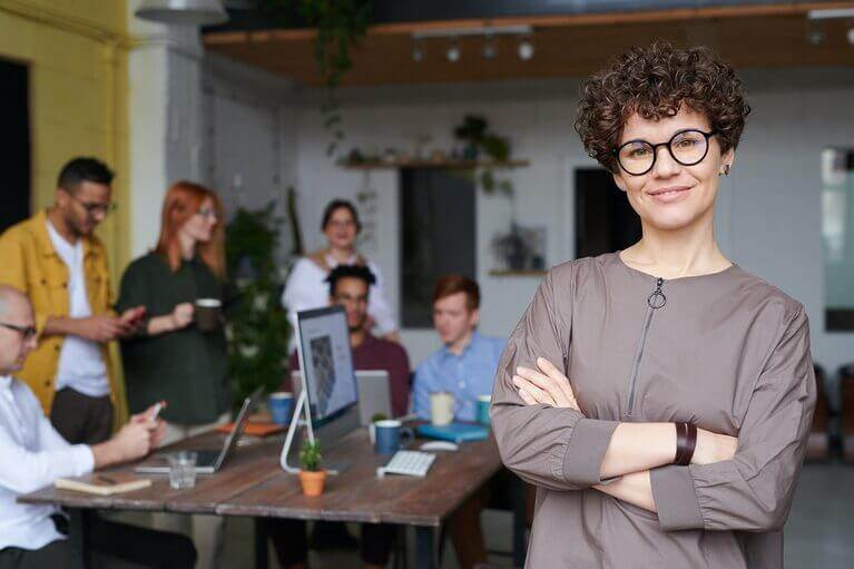 A woman in glasses sharing how copywriting helps businesses grow their site rank and traffic.