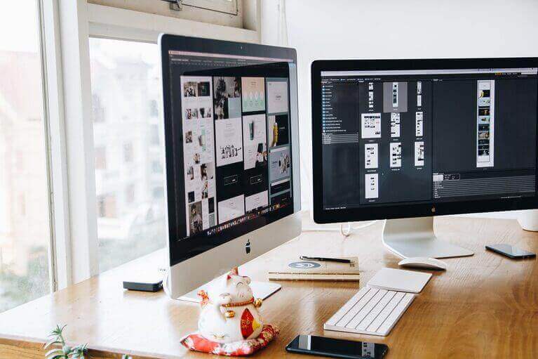 A desk with two monitors and a mouse for copywriting tasks.