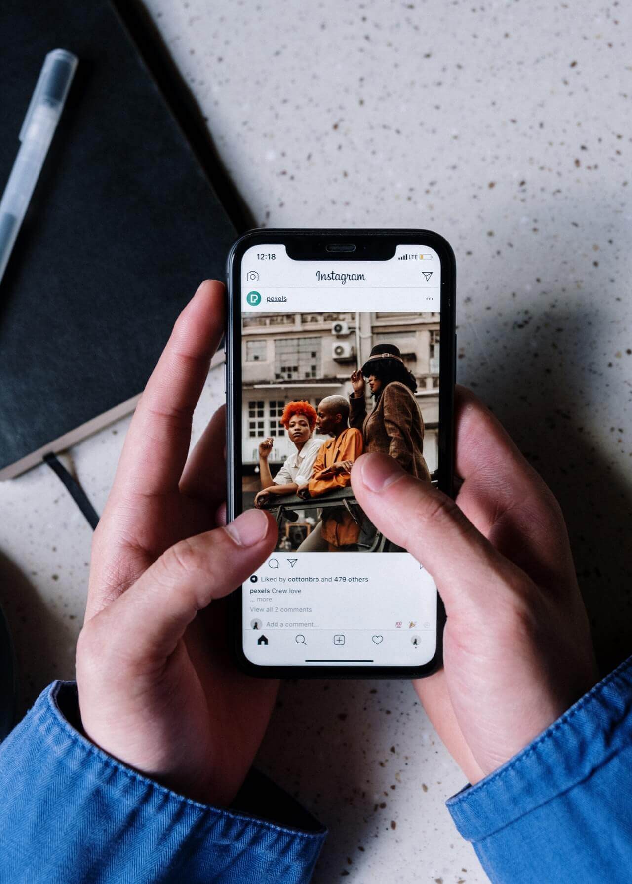 A person holding a phone with an Instagram engagement.