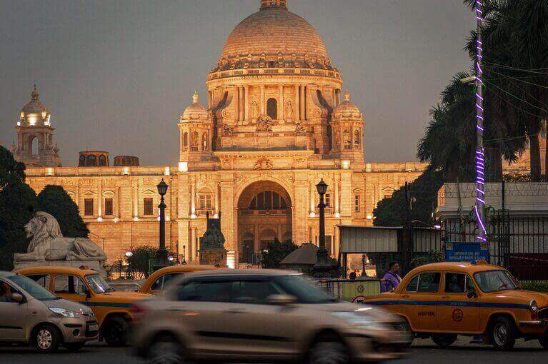 An ornate building with taxis in front of it is a description, not a question about copywriter salaries in India.
